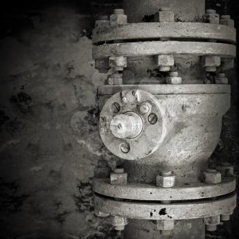 Old rusted industrial valve. Monochrome closeup photo