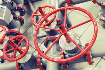 Red industrial valves on modern pipeline system