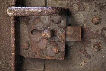 Old rusted lock on dark steel door