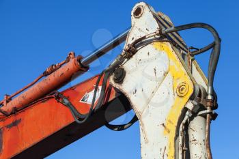 Colorful fragment of industrial excavator and blue sky