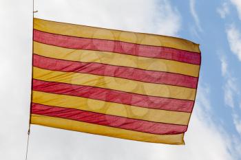 Flag Catalonia above blue cloudy sky