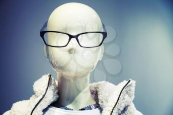Portrait of white dummy wearing black glasses in the clothing store, vintage toned photo with instagram filter effect