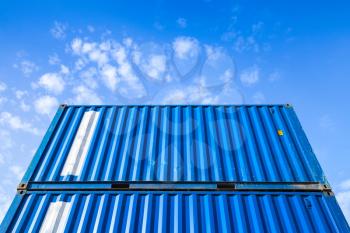Blue steel Industrial cargo containers are stacked in the storage area