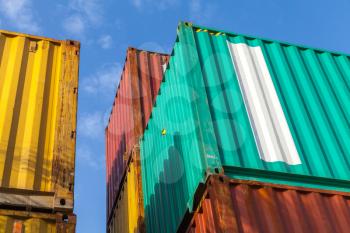 Colorful metal Industrial cargo containers stacked under blue cloudy sky