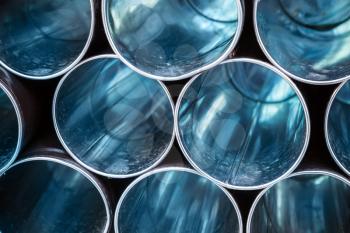 Abstract industrial background, empty blue shining metal tubes