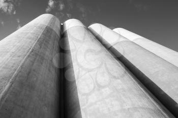 Abstract industrial architecture fragment, large tanks made of concrete for storage of bulk materials