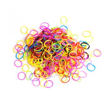 Pile of small round colorful rubber bands for making rainbow loom bracelets isolated on white background