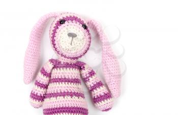 Funny knitted rabbit toy portrait over white wall background