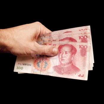 Chinese 100 yuan renminbi banknotes in male hand isolated on black background