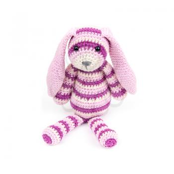 Knitted rabbit toy is sitting over white background with soft shadow