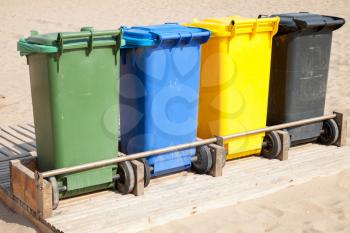 Colorful plastic containers in a row for separate garbage collection