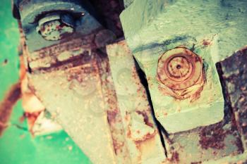 Old rusted industrial details, nuts and bolt, selective focus, shallow DOF, vintage toned photo with old style filter effect