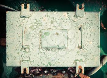 Old industrial box cover with handles, vintage toned photo with old style filter effect