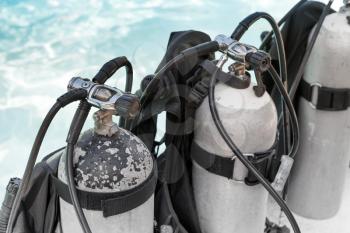 Row of personal tanks with compressed air for using during a diving trips