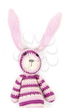 Funny knitted rabbit toy with ears up, portrait on a white background