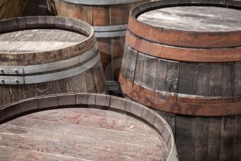Group of old wooden barrels, selective focus on a foreground