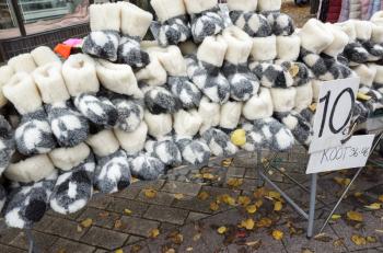 Pile of gray traditional woolen slippers on traditional Finnish fair with price label