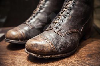 Old used shoes made of genuine leather, close up photo with selective focus