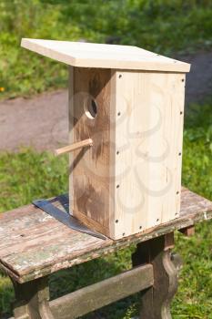 Uncolored homemade birdhouse made of wood