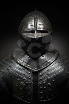 Ancient metal armor of the medieval knight. Dark vertical photo
