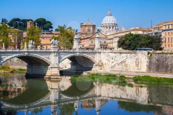 Classical Rome cityscape with Ponte Vittorio Emanuele II. It is a bridge in Rome constructed to designs of 1886 by the architect Ennio De Rossi. St. Peters Basilica  dome dominates the skyline