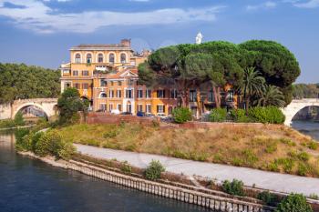 Cityscape of Rome in summer evening. The Tiber Island in southern bend of Tiber river