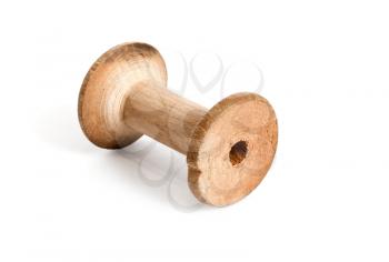 Old wooden empty reel of thread on white background
