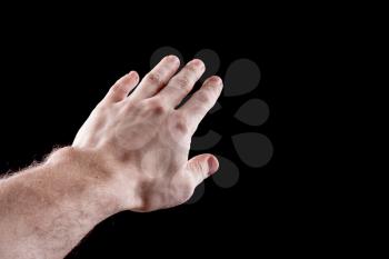 Man's hand isolated on black background