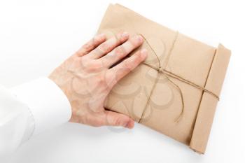 Male hand and envelope tied with a rope on white background