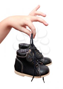 Small black shoes in the children's hands