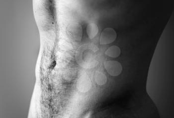 Flat sporty male belly. Closeup black and white photo with shallow depth of field