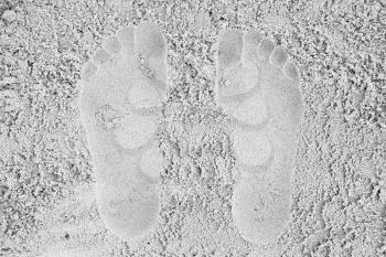 Man footprints in white sand on the beach