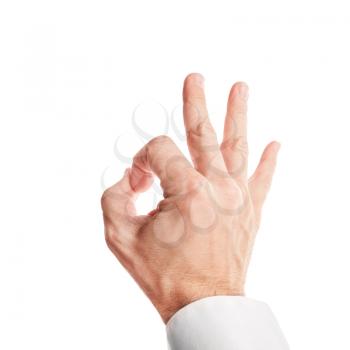 Closeup photo of business man hand showing ok acceptance sign isolated on white background