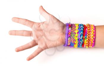 Hand with colorful rubber rainbow loom bracelets on white background, trendy kids fashion accessories 
