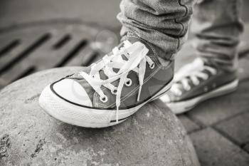 Brand new shoes, urban walking theme. Black and white photo with selective focus and shallow DOF