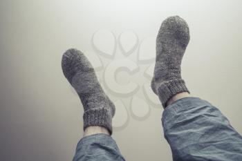 Male feet in gray woolen socks, retro style tonal correction photo filter