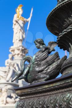 Cupid on a swan, bronze statue decoration of old street lamp near Austrian Parliament Building, Vienna, Austria. It was erected in 1900. Selective focus