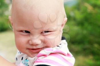 Funny smiling baby girl outdoor summer closeup portrait