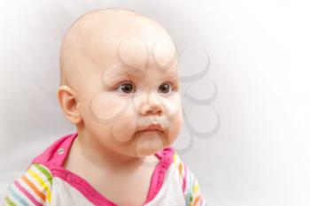 Little brown eyed Caucasian baby studio portrait on gray background