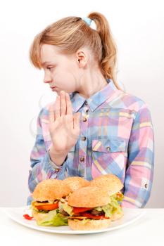 Little blond Caucasian girl saying hamburgers: No