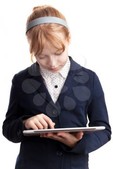 Little blond girl works on tablet device on white background