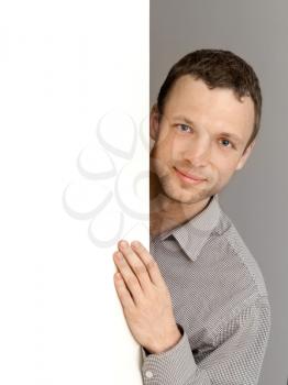 Young Caucasian Man, vertical studio portrait with white wall