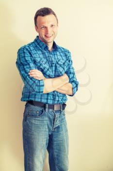Portrait of young Caucasian man in blue checkered shirt. Instagram toned effect