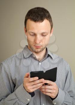 Young Caucasian man works on his smart phone