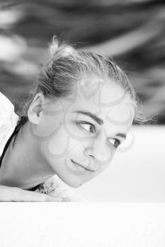 Beautiful blond Caucasian girl  teenager, closeup outdoor portrait over blurred background