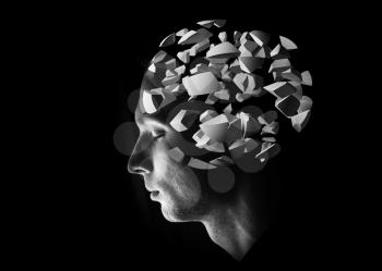 Male head profile with 3d explosion brain fragments on black background