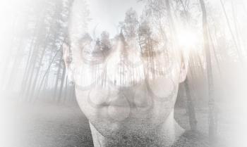 Young man, portrait with closed eyes combined with forest landscape, double exposure photo effect