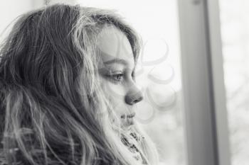 Monochrome closeup profile portrait of beautiful blond teenage girl