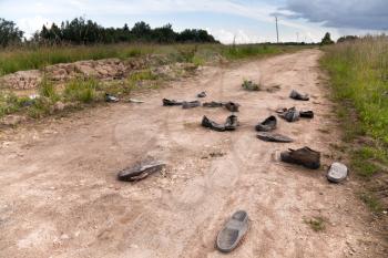 Old rural road with abandoned shoes