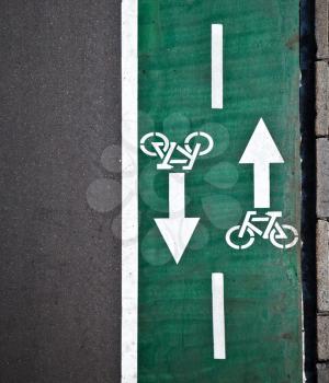 Green bicycle lane with road marking background texture